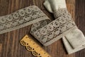 Knitted openwork linen ribbon tapes in rural style of rustics cotton eco natural on wood ground