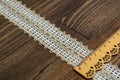 Knitted openwork linen ribbon tapes in rural style of rustics cotton eco natural on wood ground