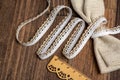 Knitted openwork linen ribbon tapes in rural style of rustics cotton eco natural on wood ground