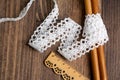 Knitted openwork linen ribbon tapes in rural style of rustics cotton eco natural on wood ground Royalty Free Stock Photo