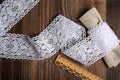 Knitted openwork linen ribbon tapes in rural style of rustics cotton eco natural on wood ground