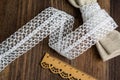 Knitted openwork linen ribbon tapes in rural style of rustics cotton eco natural on wood ground