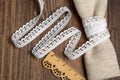 Knitted openwork linen ribbon tapes in rural style of rustics cotton eco natural on wood ground