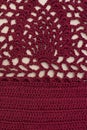 Knitted openwork pattern, burgundy color. Textured fabric