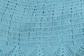 Knitted openwork pattern, turquoise color. Textured fabric. Handmade