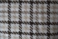 Knitted pattern of threads in brown, white and beige. Knitted background. Knitted wallpaper. Knitted texture. Soft