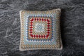 Knitted Pillow made of cotton threads with a pattern, white, red and pale blue, Royalty Free Stock Photo