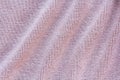 Knitted pink fabric texture with large diagonal fold Royalty Free Stock Photo