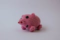 Knitted pink pig with crimson vest on white background, mini pig, handmade, toys