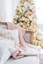 Knitted plaid and pillows on a sofa at home on a christmas eve. Home cosiness Royalty Free Stock Photo