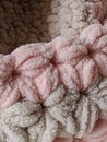 Knitted product from soft plush yarn with a clear pattern in pleasant pastel colors.