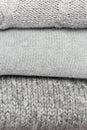 Knitted products from gray wool stacked close-up.