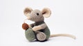 Knitted Rat Toy: Playful Poses Of A Crocheted Mouse Holding Yarn