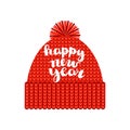 A knitted red cap with a pompom with the inscription `Happy new year`. Isolated on a white background. Autumn or winter seasonal a