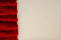 Knitted reddish blanket on a white background with copy space