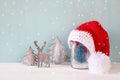knitted santa hat on mason jar with christmas tree