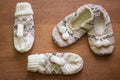 Knitted slippers with pompoms and mittens