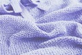 Knitted sweater of lavender color, selective focus