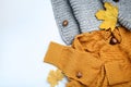 Sweater, scarf with chestnuts, acorns and autumn leafs Royalty Free Stock Photo