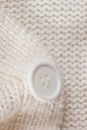 Knitted texture with a white button Royalty Free Stock Photo