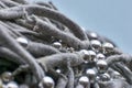 Knitted threads with silver coloured beads against blue