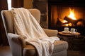 a knitted throw draped over a comfortable chair near a spa fireplace