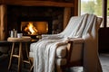 a knitted throw draped over a comfortable chair near a spa fireplace