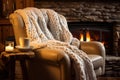 a knitted throw draped over a comfortable chair near a spa fireplace