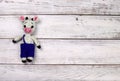 knitted toy bull on a light wooden background. New Year greeting card with free copy space for text