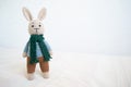 Knitted toy hare on a white background. Crochet toy.