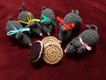 Rats with festive colorful ribbons around their neck gathered around cookies.