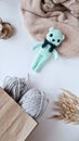 Knitted toys on a white table. Natural. Knitted bear. Product layout. Knitting. Hobby.