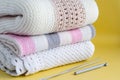 Knitted warm plaids of light color, bedding on a yellow background Royalty Free Stock Photo