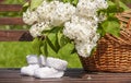 Knitted white baby booties on floral background