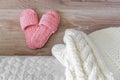 Knitted white bedspread and pink women`s Slippers near the bed Royalty Free Stock Photo