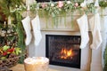 Knitted White Christmas Stockings Hanging On A Fireplace Mantle