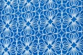 Knitted white flowers on a blue background Royalty Free Stock Photo