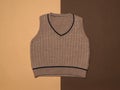 Knitted women`s vest on a background of two brown colors Royalty Free Stock Photo