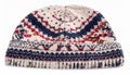 Knitted Wool Beanie Hat with Geometric Patterns in Red and Blue on White Background Royalty Free Stock Photo