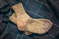Knitted wool socks pair on fabric drape. warming socks. autumn mood