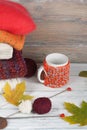 Knitted wool sweaters. Pile of knitted winter, autumn clothes on red, wooden background, sweaters, knitwear, ball, cup Royalty Free Stock Photo