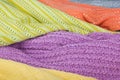 Knitted wool sweaters. Pile of knitted summer clothes on wooden background, sweaters, knitwear, space for text Royalty Free Stock Photo