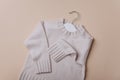 Knitted wool warm fluffy sweater. Handcraft knitting woolen fabric surface. Merino wool, cashmere baby clothes. Top view