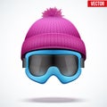 Knitted woolen cap with snow goggles. Winter