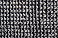 Knitted woolen white and black background. Texture of black and white wool close-up. Knitted fabric, handmade, knitting