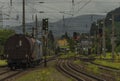 Knittelfeld station with cargo train and color semaphore in cloudy summer day Royalty Free Stock Photo