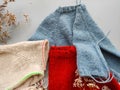 Knitter`s table with unfinished baby sweaters