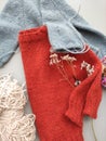 Knitter`s table with unfinished baby sweaters