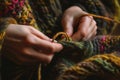 knitters hands focusing on interlocking wool loops