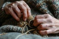 knitters hands focusing on interlocking wool loops